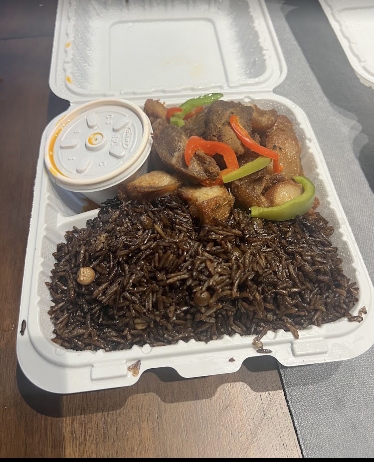 To-go tray of djon djon rice and fried meat with pikliz at Klas La